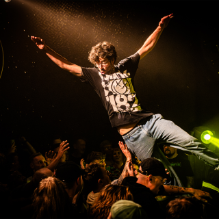 man crowdsurfing at no barrier